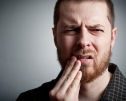 man with mouth pain