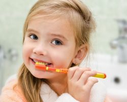 little girl brushing her teeth