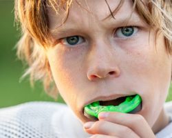 young boy with an athletic mouthguard