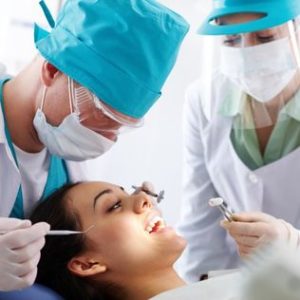 Dental professionals performing oral surgery on a patient, demonstrating advanced techniques for procedures like bone grafts and tooth extractions at Times Square Dental in Boise, ID.